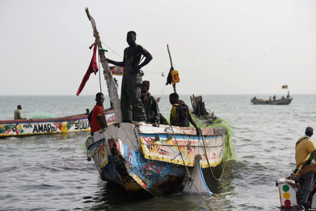 Fishermen land their boat at the beach near the coastal town of Joal-Fadiouth, Senegal, April 10, 201